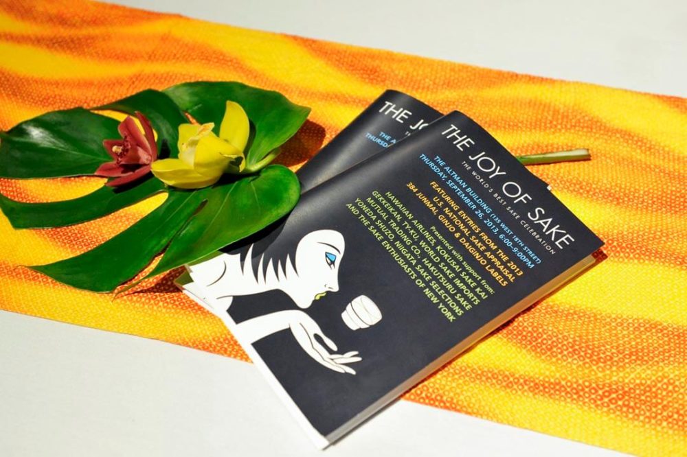 jos13ny010 Two programs with monstera and orchid flowers on yellow and orange cloth (2013 New York)